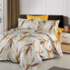 Ropa de cama blanca y amarilla con copos