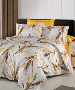 Ropa de cama blanca y amarilla con copos